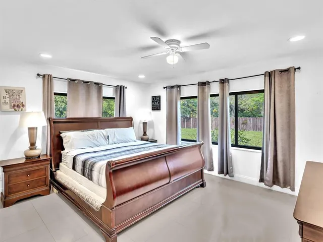 a bed room with a bed and a large window