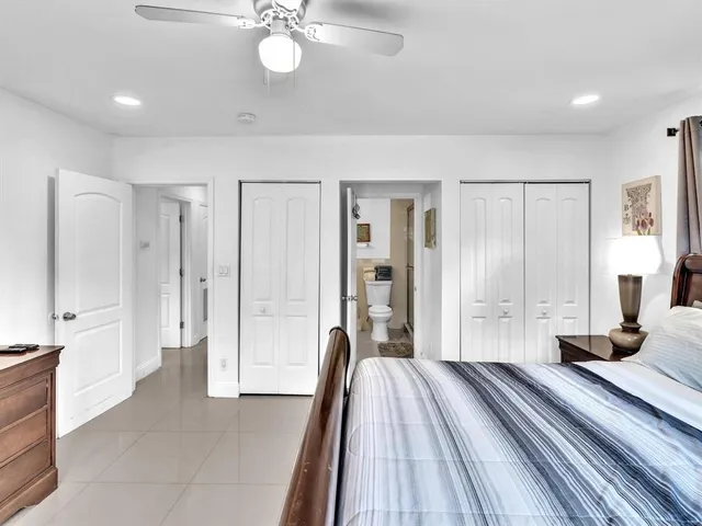 a spacious bedroom with a bed and a chandelier
