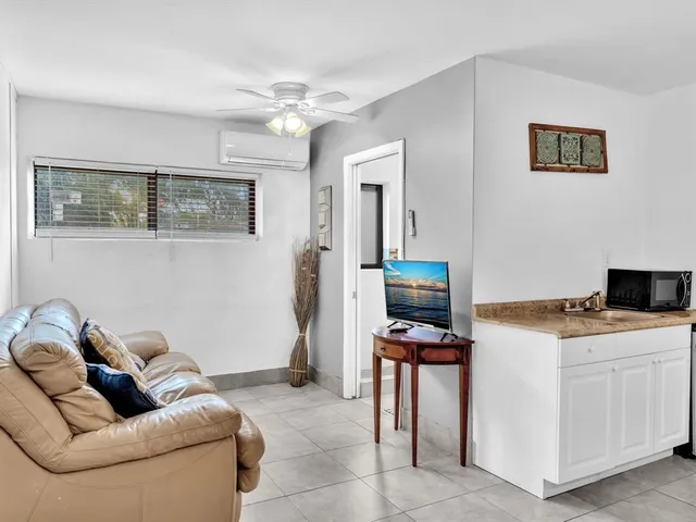 a living room with furniture and flat screen tv