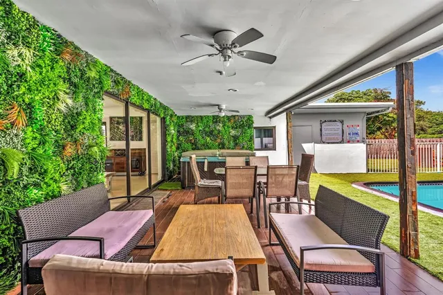 a view of an outdoor dining space with a table and chairs