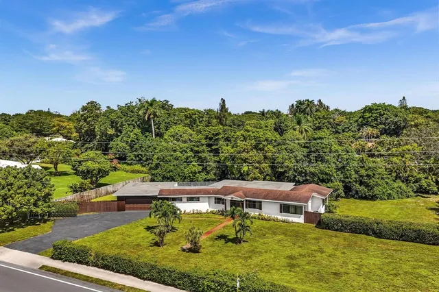an aerial view of a house with a yard basket ball court