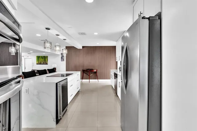a large kitchen with a large counter top appliances and cabinets
