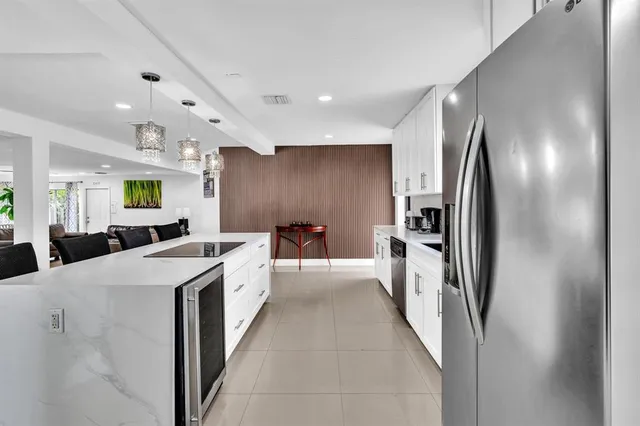 a large kitchen with a large counter top cabinets and stainless steel appliances