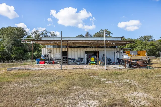 a view of a house with backyard and sitting area