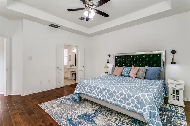 a bedroom with a large bed and a chandelier