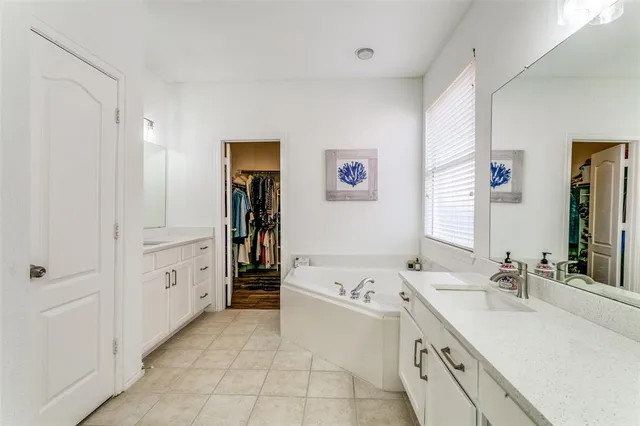a bathroom with a tub sink and a mirror