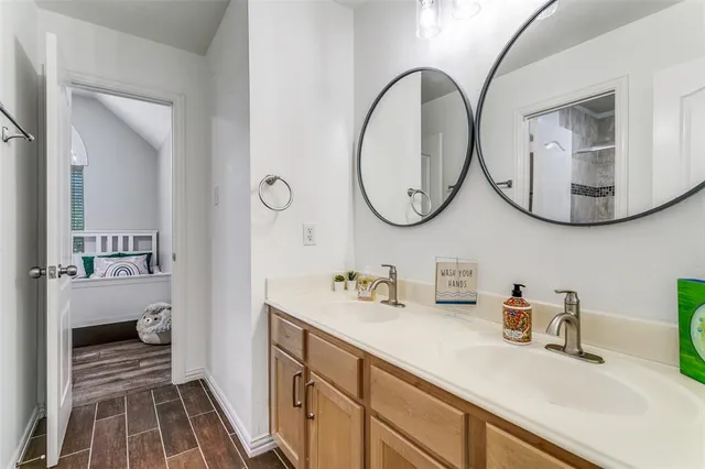 a bathroom with a double vanity sink and a mirror