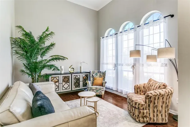 a living room with furniture flowerpot and window