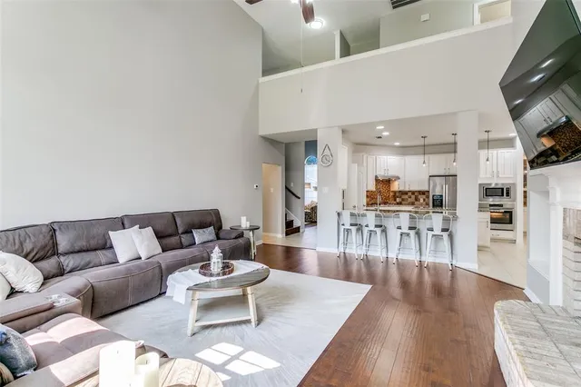 a living room with furniture wooden floor and a flat screen tv