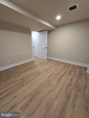 an empty room with wooden floor
