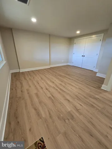 an empty room with wooden floor