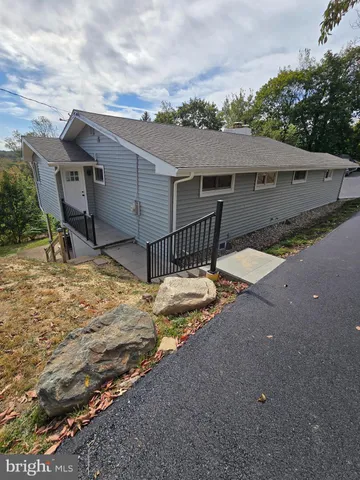 a view of a house with a yard and street view