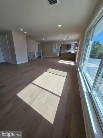 a view of kitchen with wooden floor and electronic appliances