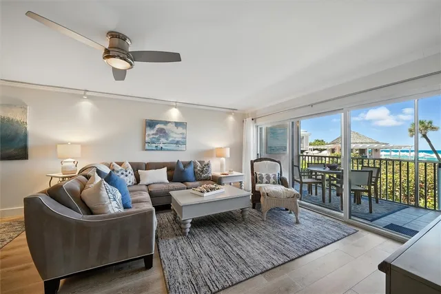 a living room with furniture a flat screen tv and a table