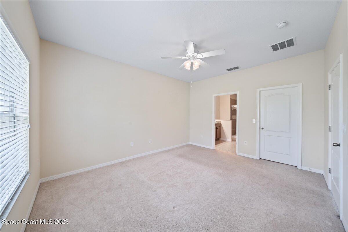 3680 Funston Circle Melbourne, FL 32940 - Photo 16 of 48 an empty room with a ceiling fan and a window