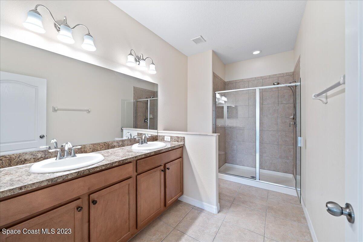3680 Funston Circle Melbourne, FL 32940 - Photo 17 of 48 a bathroom with a double vanity sink mirror and shower