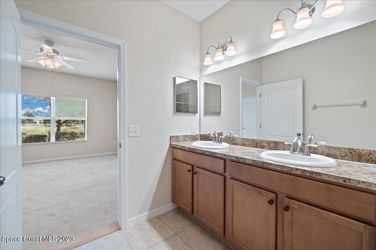 3680 Funston Circle Melbourne, FL 32940 - Photo 18 of 48 a bathroom with a granite countertop sink a large mirror and a shower