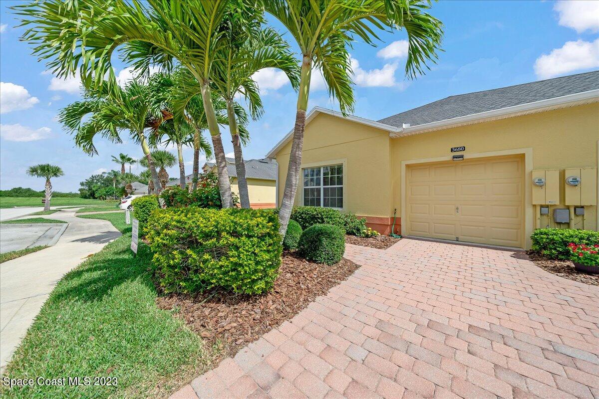 3680 Funston Circle Melbourne, FL 32940 - Photo 2 of 48 a front view of a house with a yard and a garage