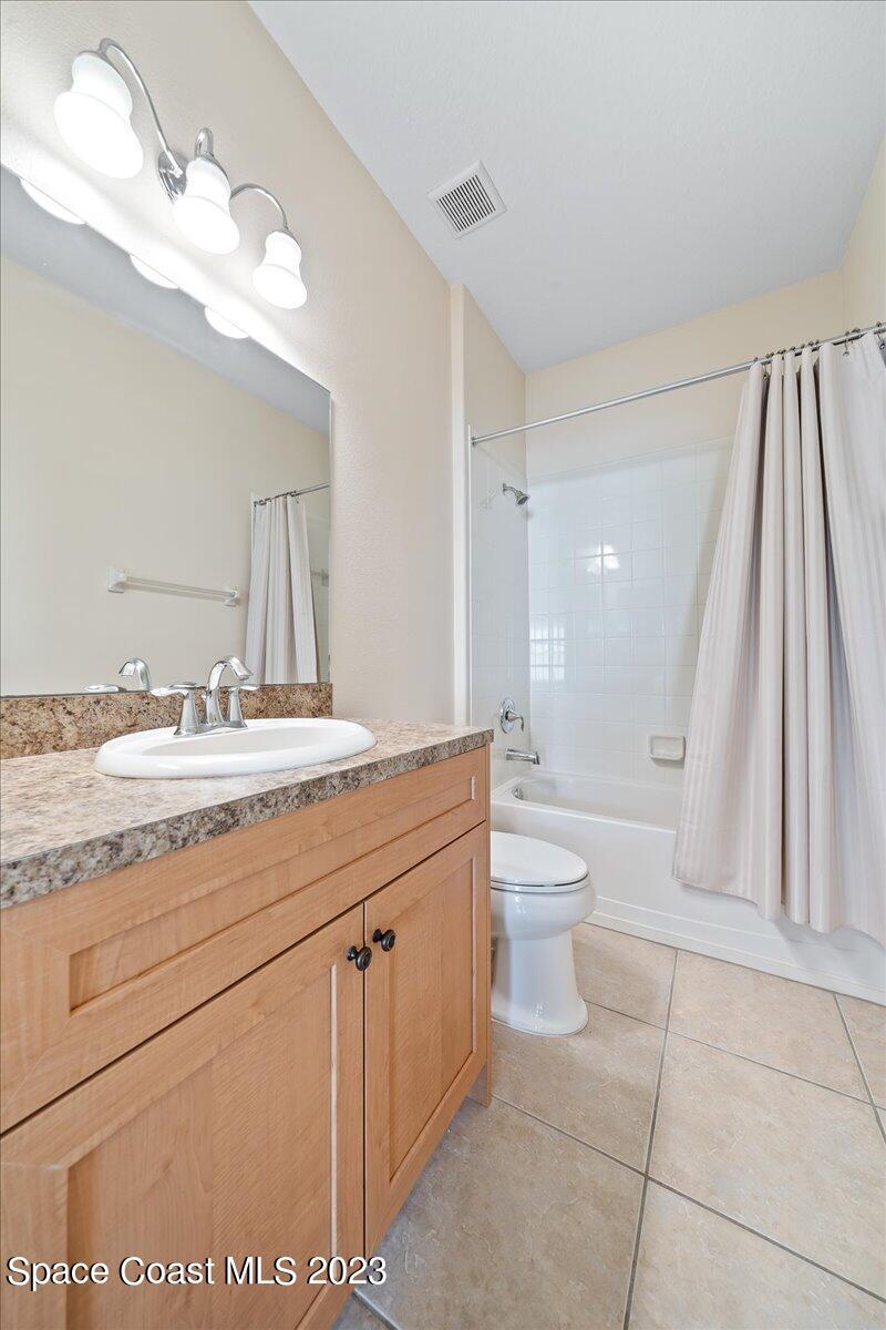 3680 Funston Circle Melbourne, FL 32940 - Photo 24 of 48 a spacious bathroom with a granite countertop sink a toilet a mirror and a shower