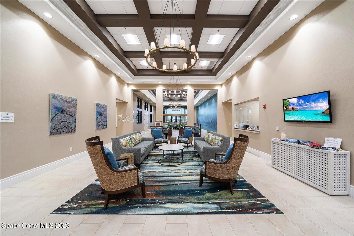 3680 Funston Circle Melbourne, FL 32940 - Photo 47 of 48 a living room with furniture a chandelier and a rug
