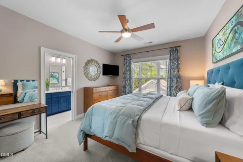 a bedroom with a bed a window and a chandelier