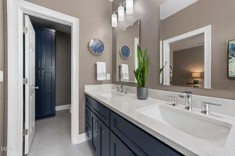 a bathroom with a double vanity sink and a mirror
