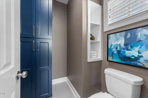 a bathroom with a toilet and a shower curtain