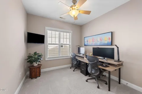 a view of a workspace with furniture and a window