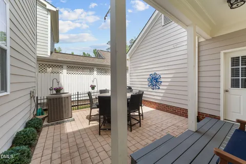 a view of a patio with table and chairs and wooden floor