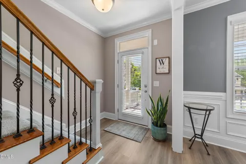 a view of staircase with wooden floor and a potted plant