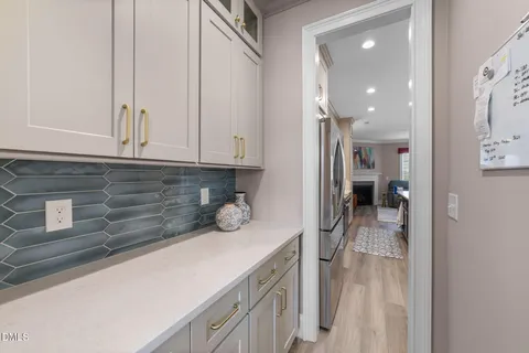 a kitchen with a refrigerator and a stove