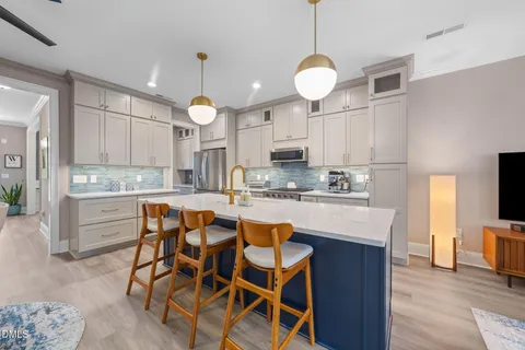 a kitchen with granite countertop wooden cabinets and white appliances