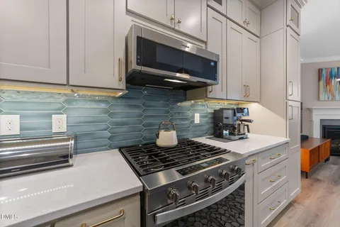a stove top oven sitting inside of a kitchen