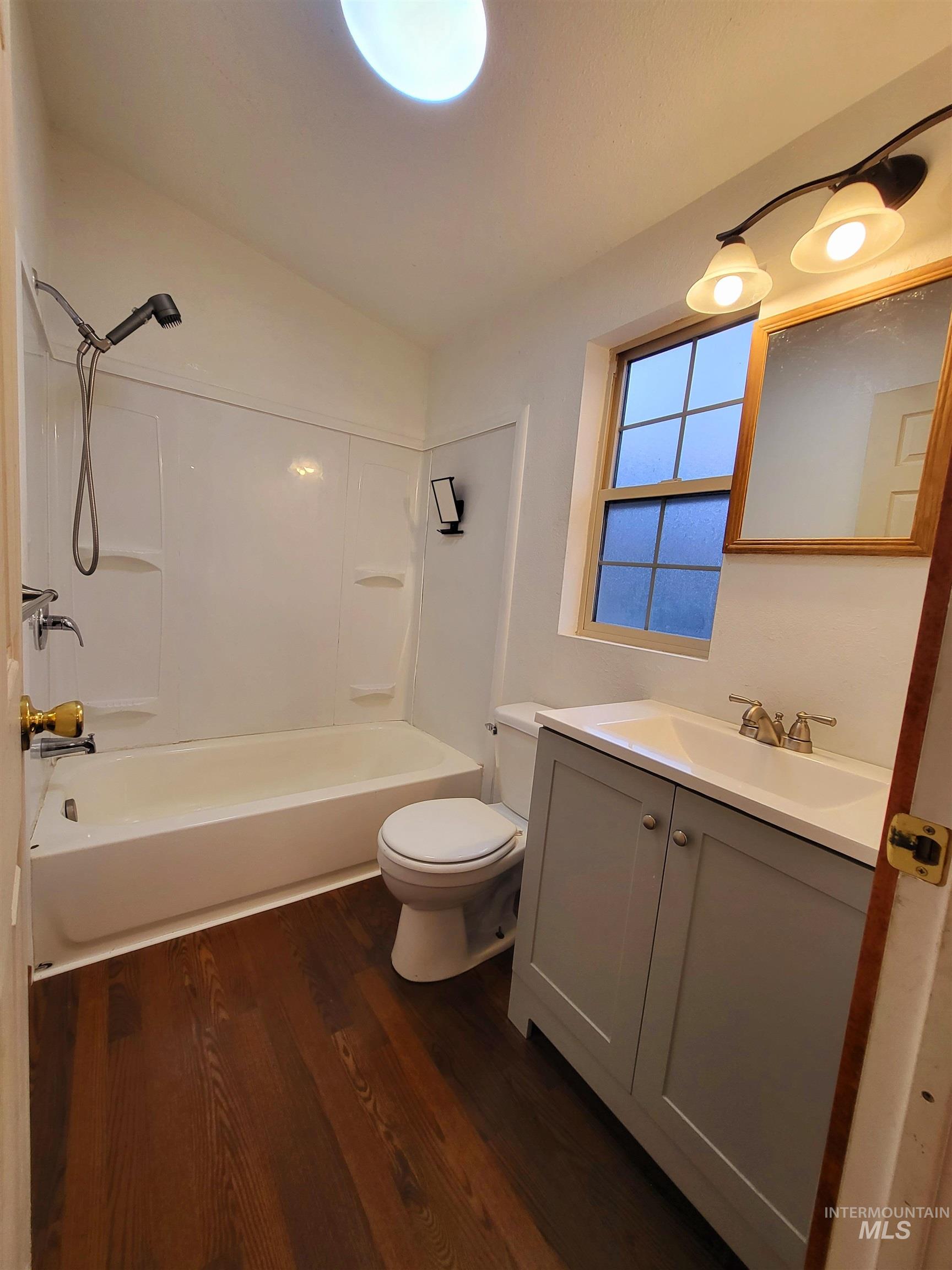 89 Waterfall Loop Orofino, ID 83544 - Photo 5 of 6 Full bathroom with shower combination, vanity, dark wood-style floors, and lofted ceiling