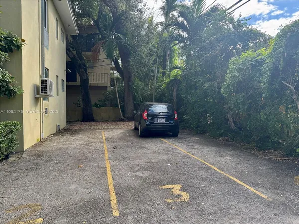 a view of a car parked in a yard