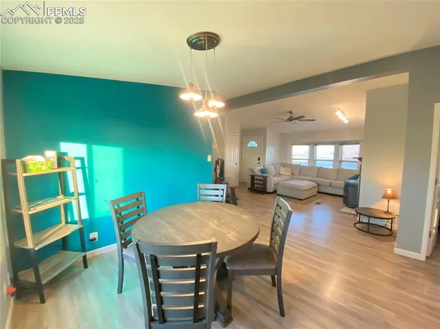 a living room with dining room and wooden floor