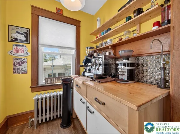 a view of kitchen with furniture and stainless steel appliances