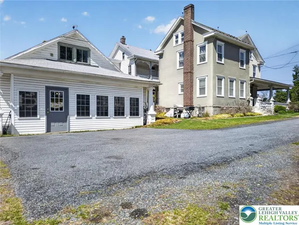 a front view of a house with a porch and a yard
