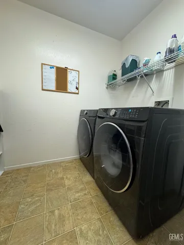 a utility room with multiple dryer and washer