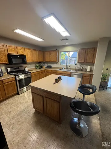 a kitchen with a stove a sink and a refrigerator