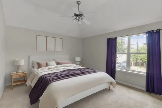 a bedroom with a bed and a window