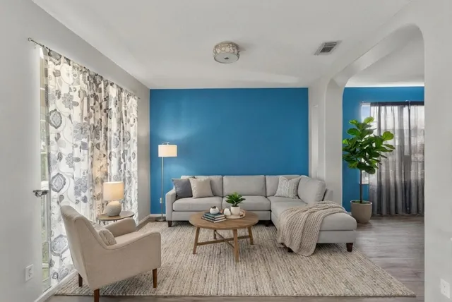 a living room with furniture and a potted plant