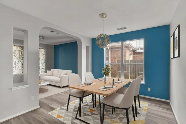 a view of a dining room with furniture window and wooden floor