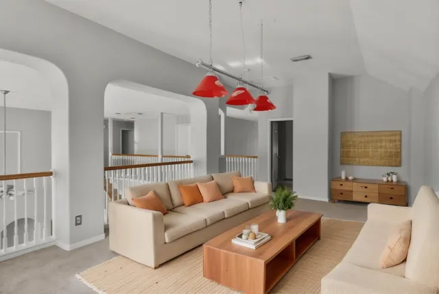 a living room with furniture and a chandelier