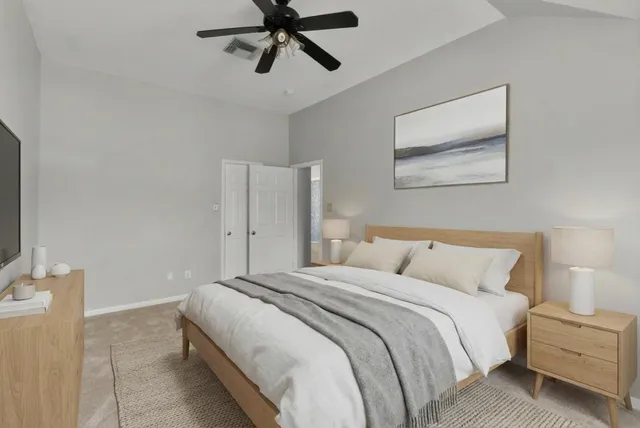 a bedroom with a bed and painting on the wall