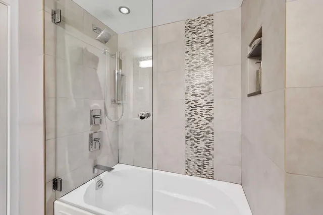 a bathroom with a bathtub and shower