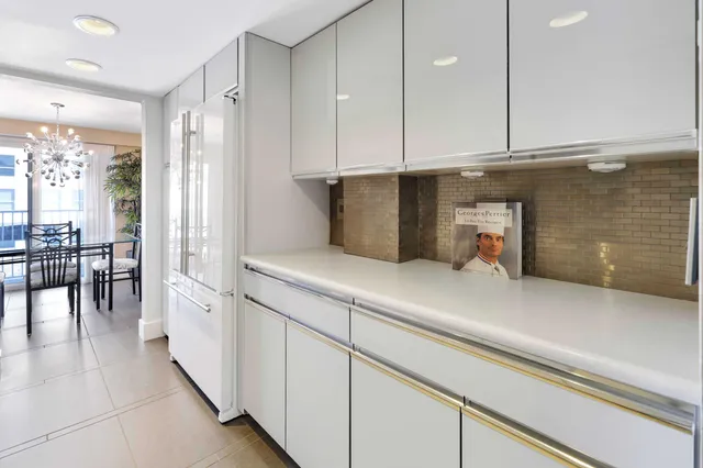 a kitchen with stainless steel appliances a refrigerator and cabinets