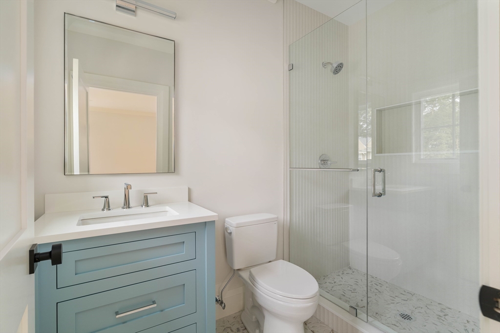 14 Bird Hill Avenue Wellesley, MA 02481 - Photo 31 of 37 a bathroom with a toilet sink vanity and shower