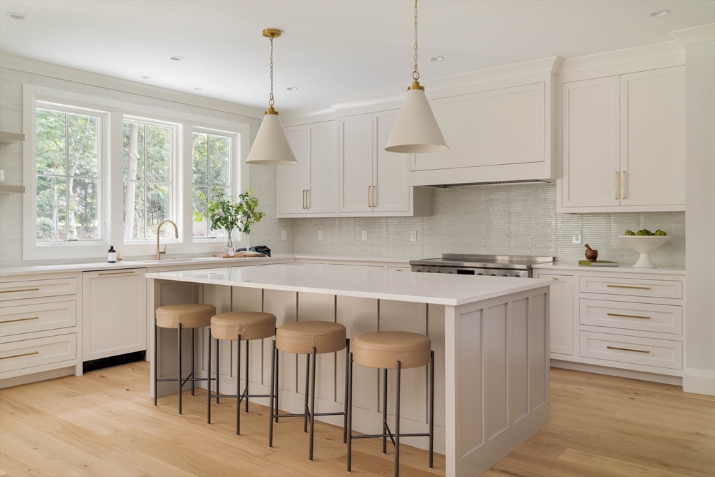 14 Bird Hill Avenue Wellesley, MA 02481 - Photo 8 of 37 a kitchen with granite countertop white cabinets and window