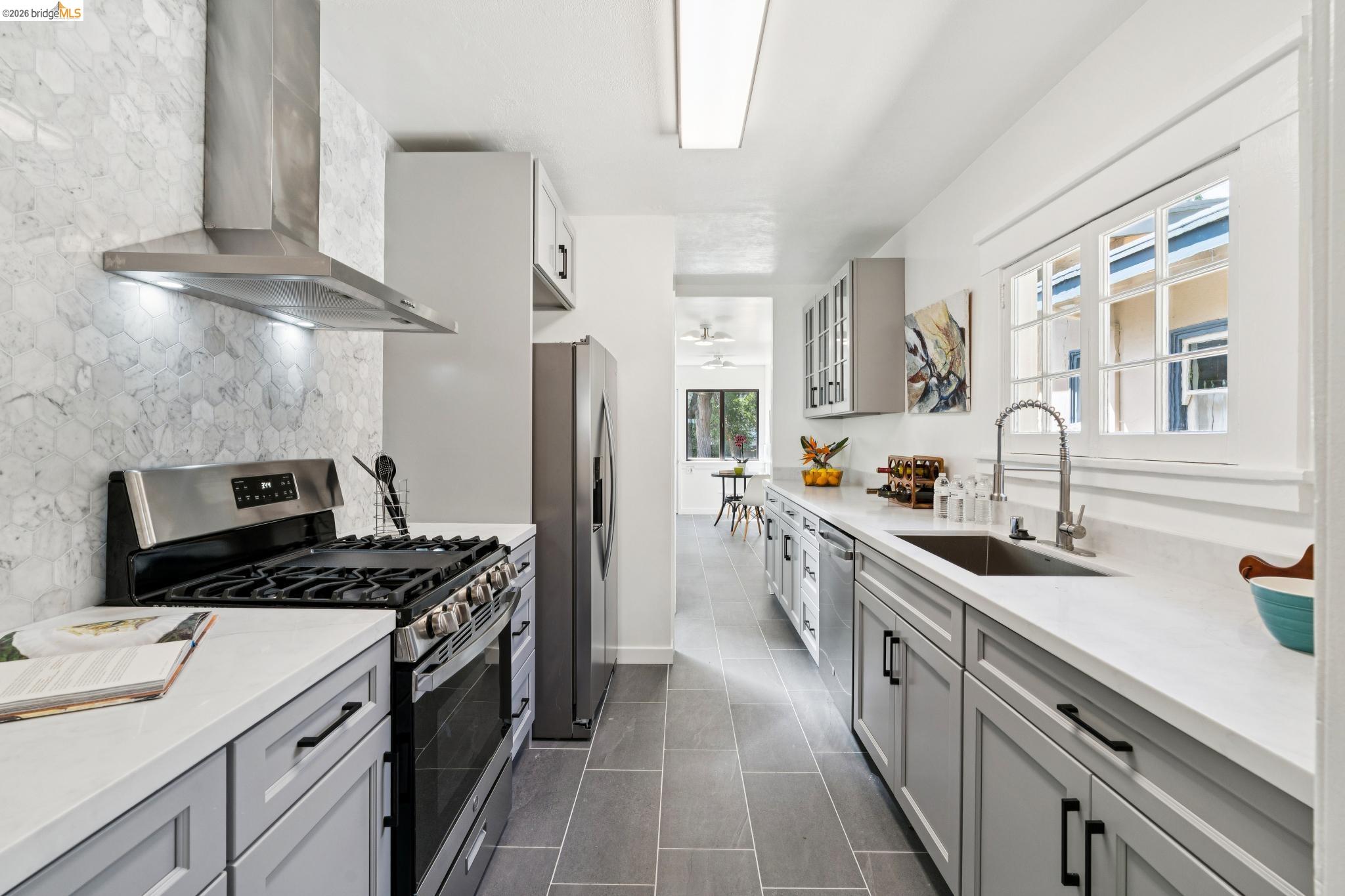 2320 Derby Street Berkeley, CA 94705 - Photo 11 of 39 a kitchen with stainless steel appliances a sink stove and refrigerator